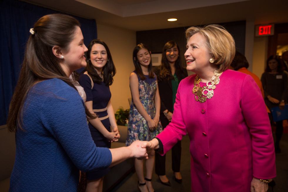 Hillary Clinton shakes hands with a student