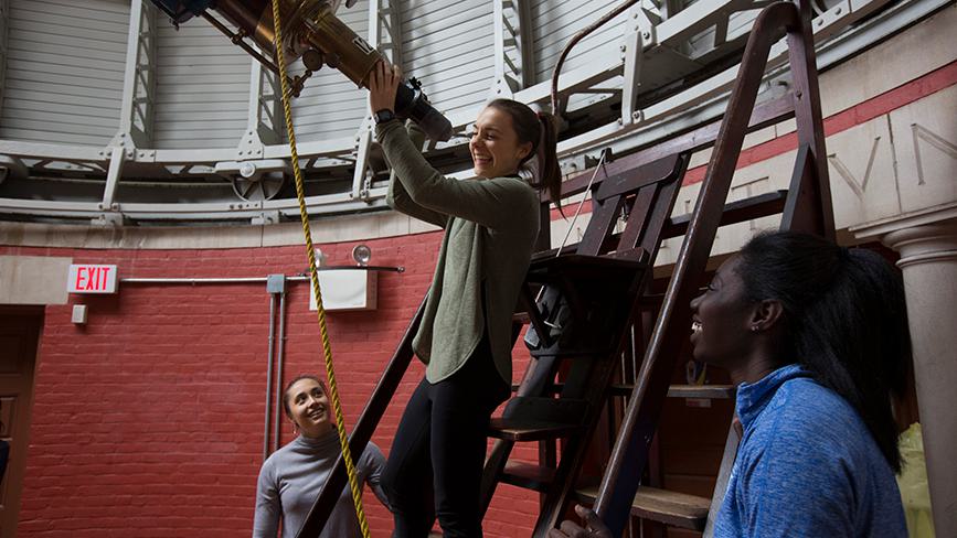Wellesley students use a telescope in the Whitin Observatory