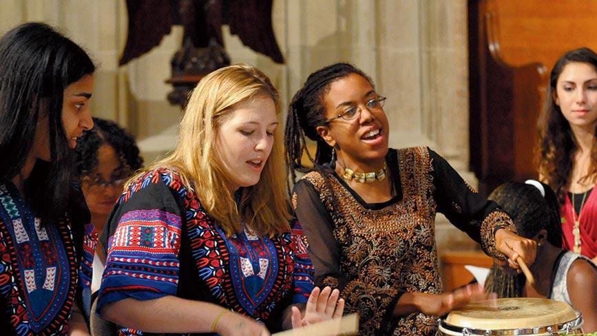 Two Wellesley College students play drums as part of Yanvalou Drum & Dance Ensemble, a group that performs the folkloric music and dance of Africa