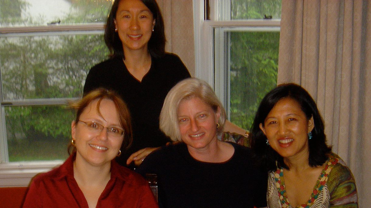 Four women group together for a photo.