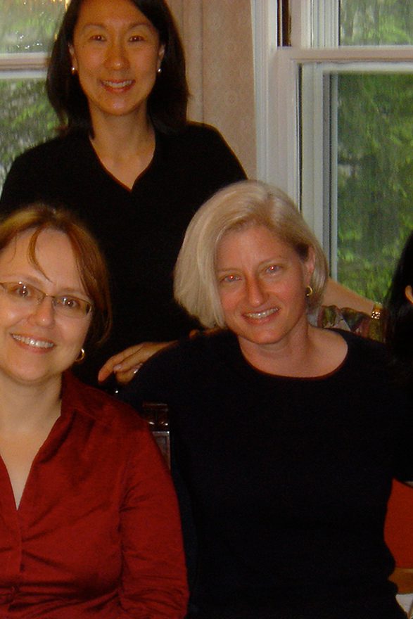 Four women group together for a photo.
