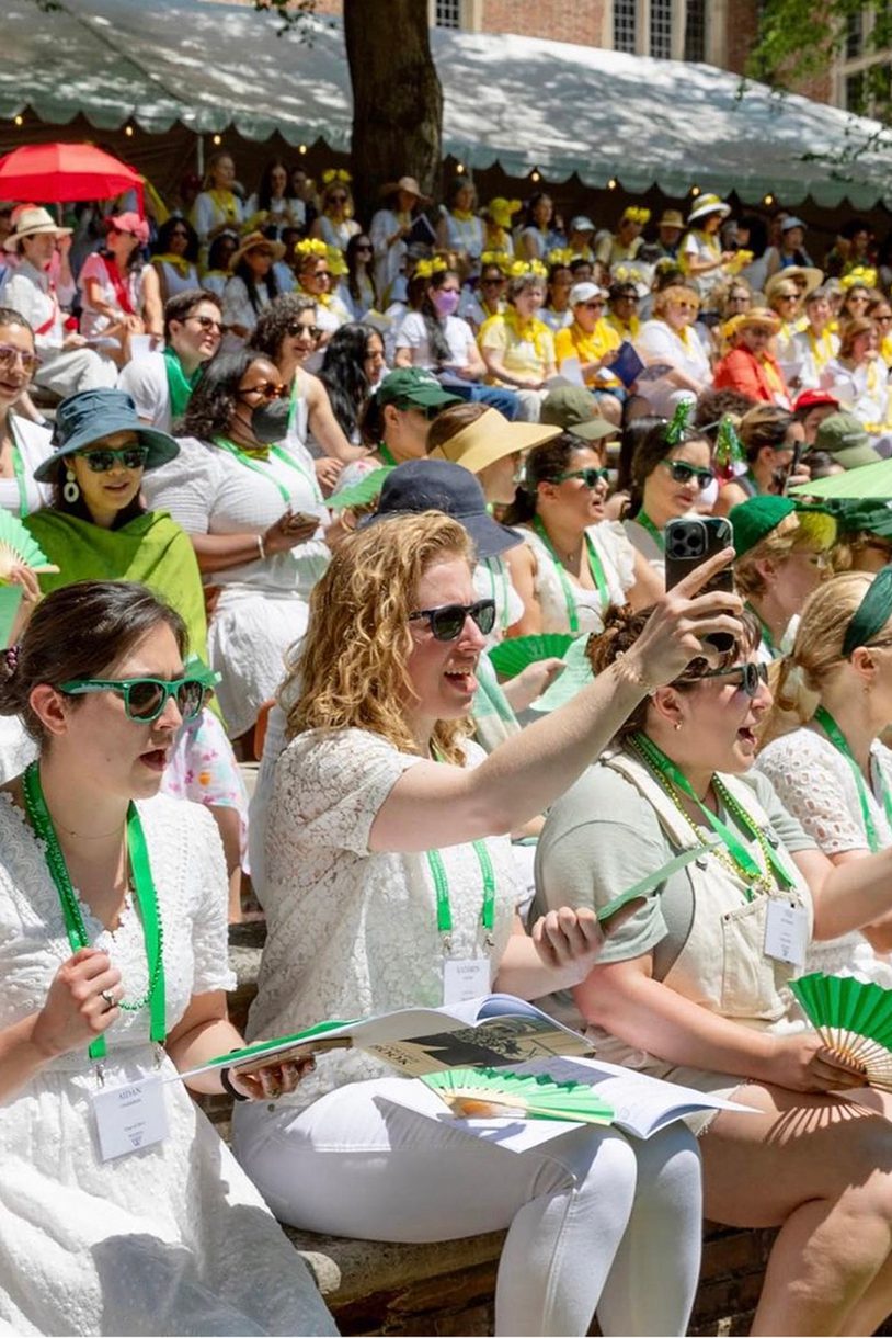 A crowd of alums during reunion dressed in white.