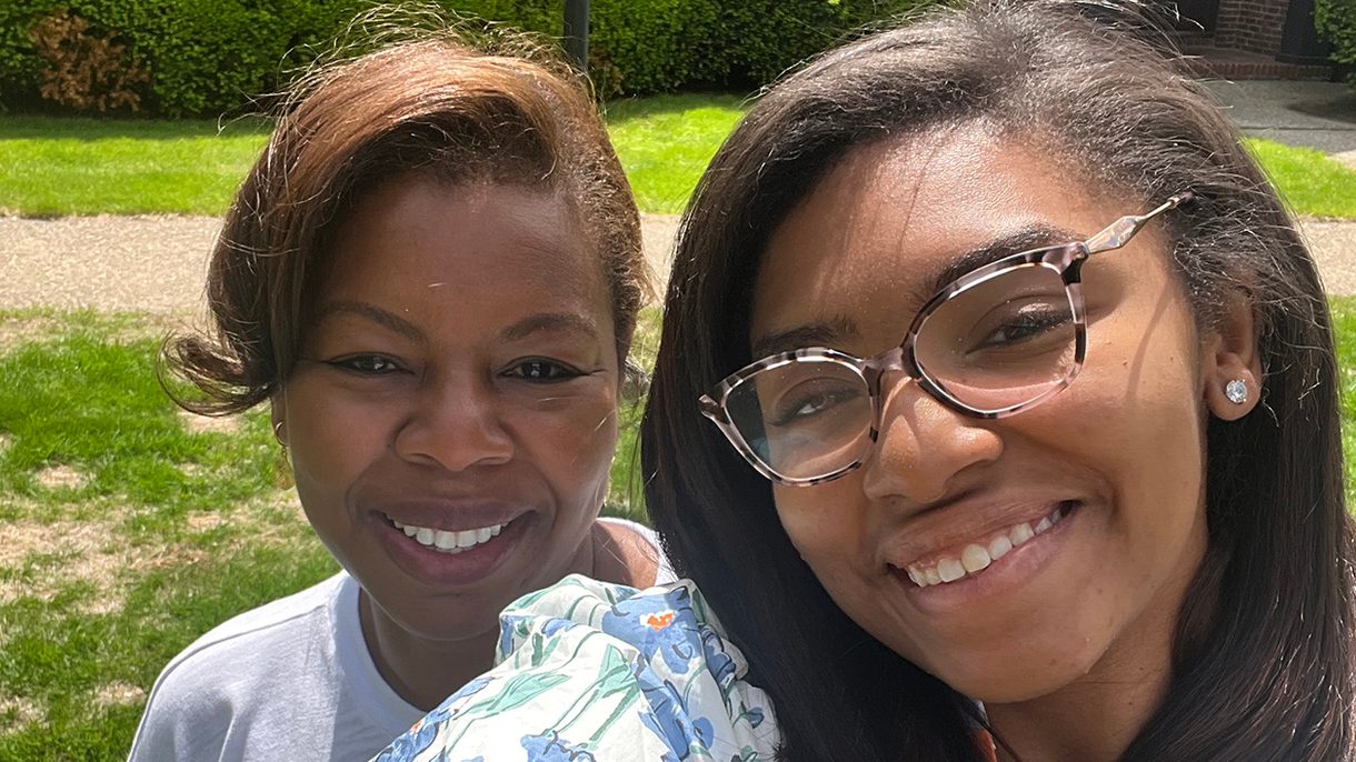 A selfie of a professor and her student smiling at the camera.