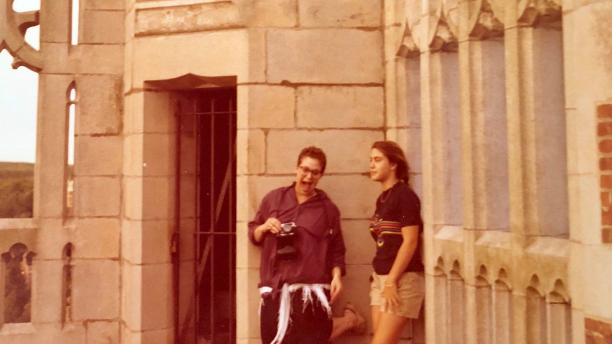 Two students stand on the roof of Tower Hall.
