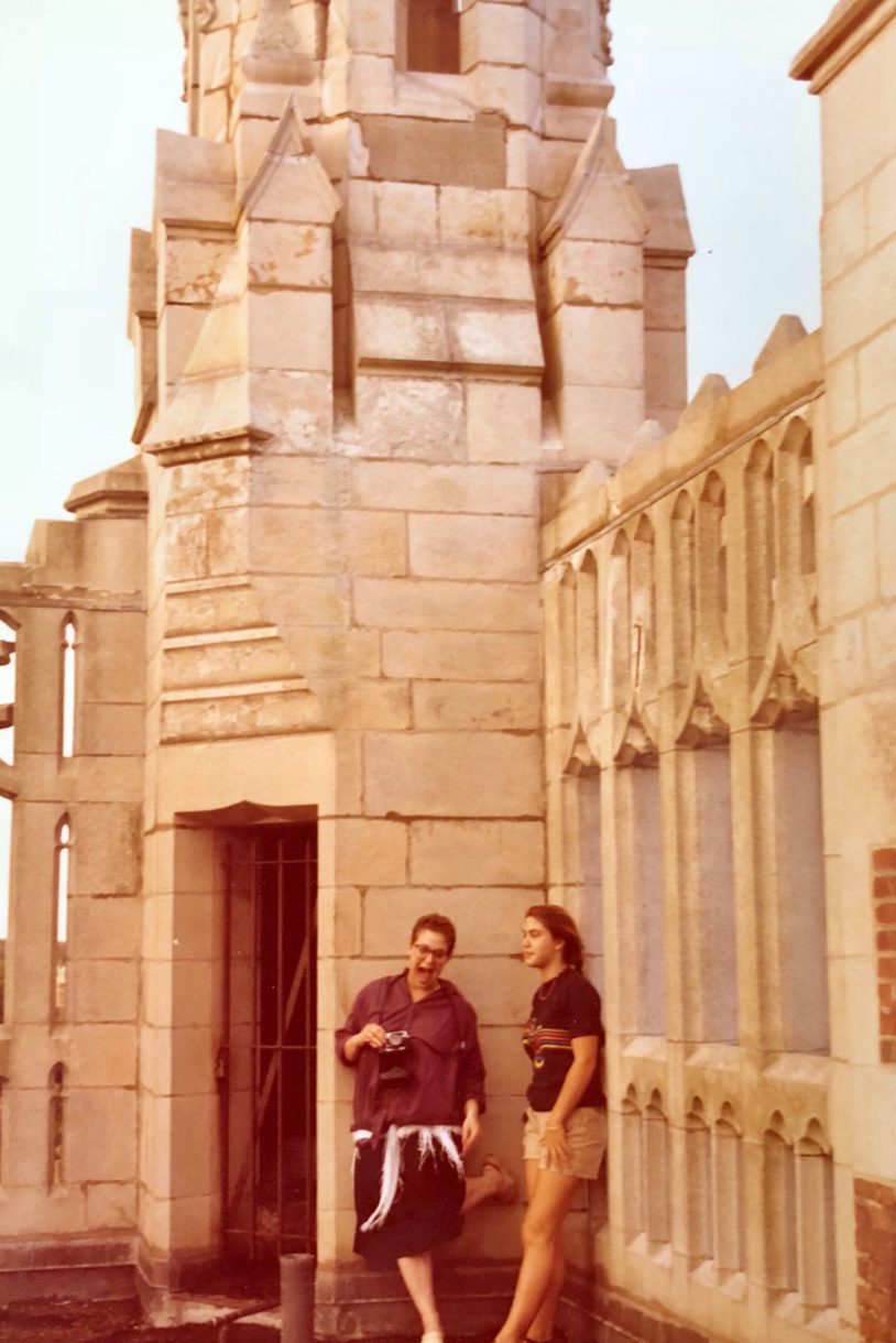 Two students stand on the roof of Tower Hall.