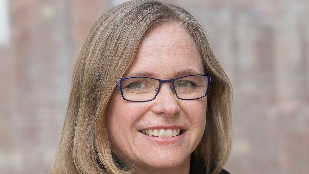 Headshot of a woman with shoulder-length blonde hair and glasses.
