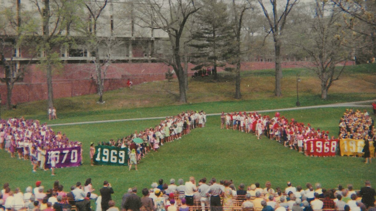 The classes of 1967, 1968, 1969 and 1970 form a human W on Severance Green.