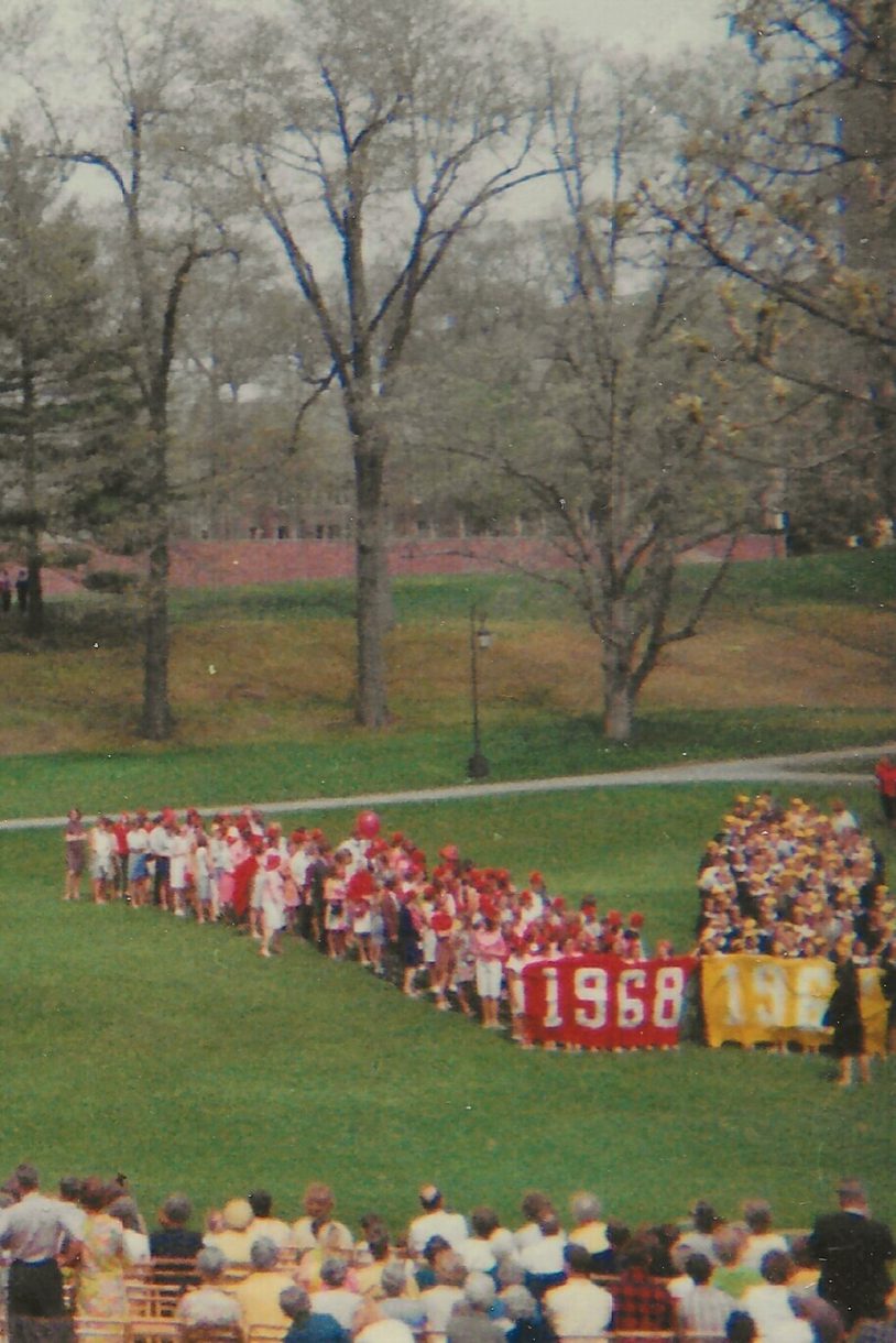 The classes of 1967, 1968, 1969 and 1970 form a human W on Severance Green.