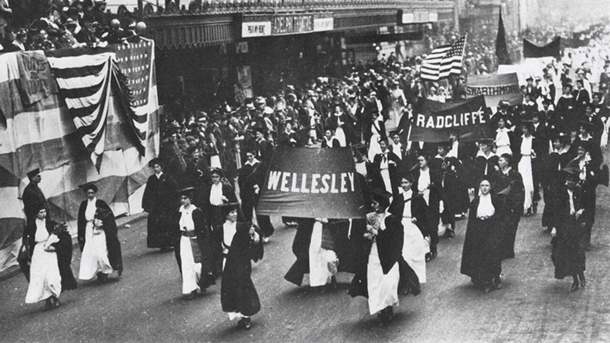Students carrying banners for Wellesley, Radcliffe, and Swarthmore participate in a march for suffrage in Philadelphia in 1915.