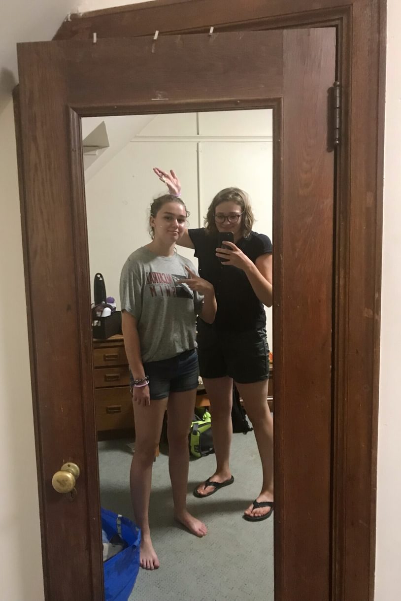 Grace and Bryn as students, reflected in a full length mirror