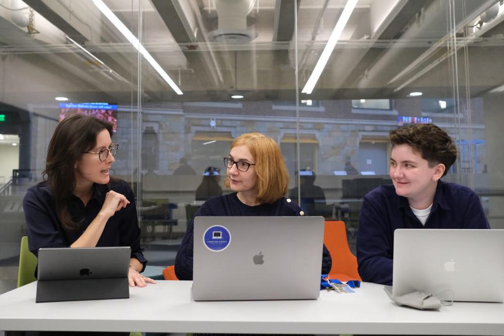 With laptops and ipads out, professors Julie Walsh and Eni Mustafaraj meet with research associate CJ Larkin.