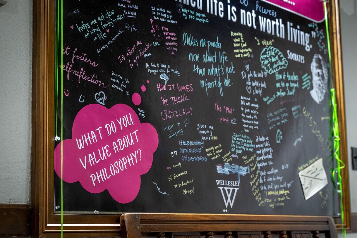 Closeup of a chalkboard with different opinions on how philosophy is valuable.