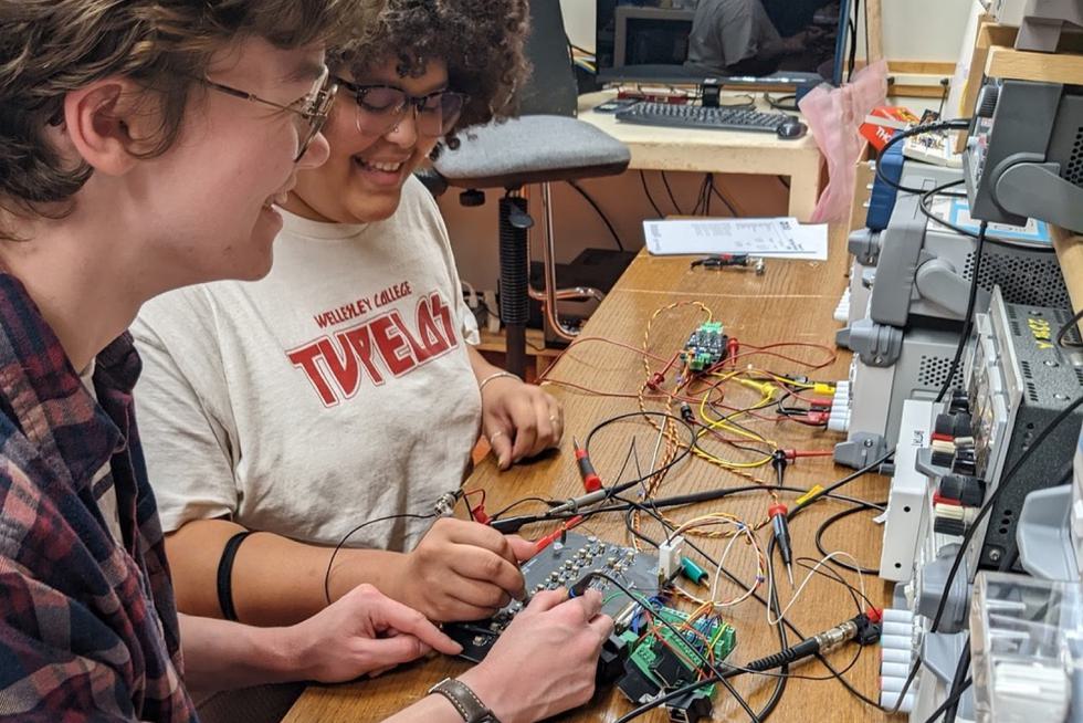Students in the Battat lab work on electronics for muon detection.