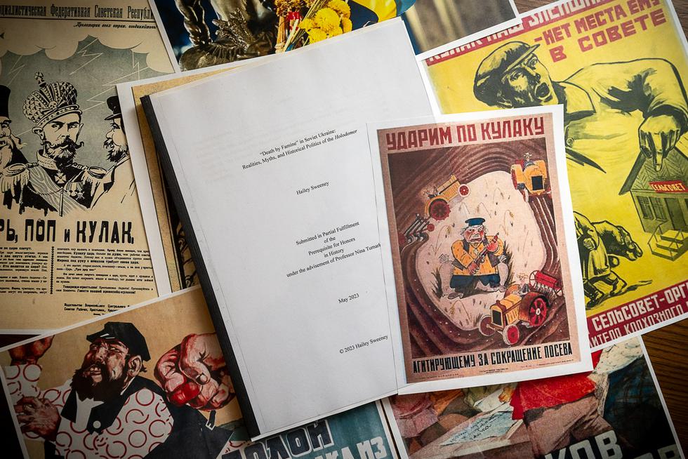 A History Department thesis laying on top of historic Russian propaganda posters.