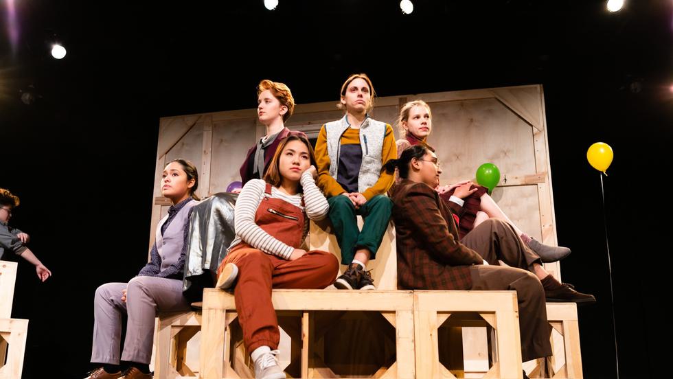 An ensemble of student actors on stage