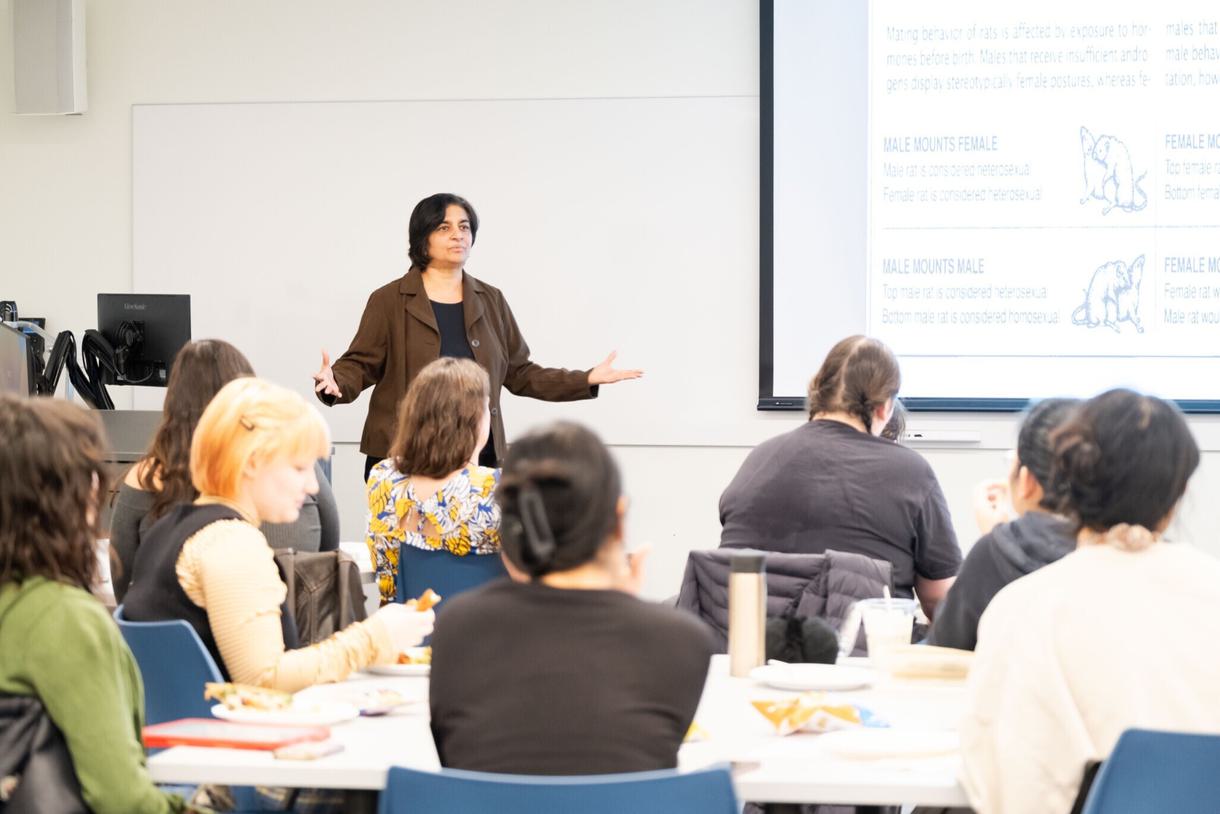 Banu Subramaniam stands in front of a class and gives a lecture.