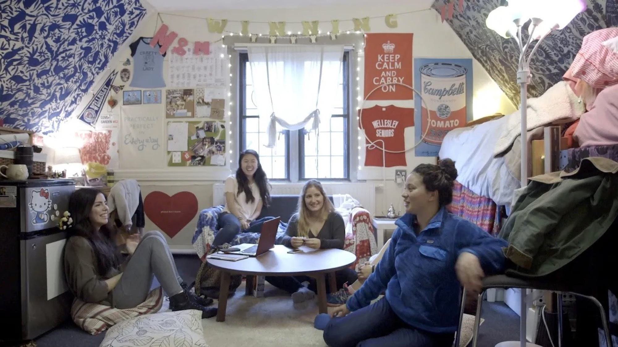 YouTube video thumbnail featuring five Wellesley students sitting and chatting in their residence hall room.