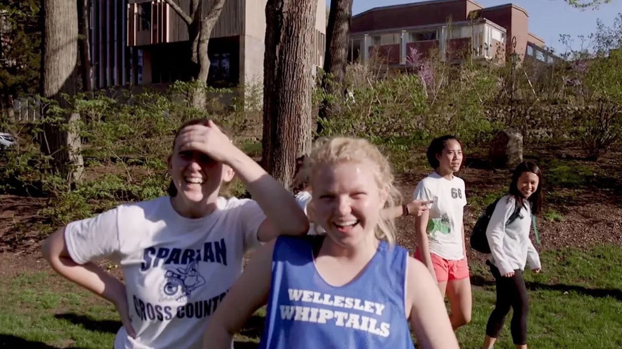 Students outside, laughing and smiling into the sun