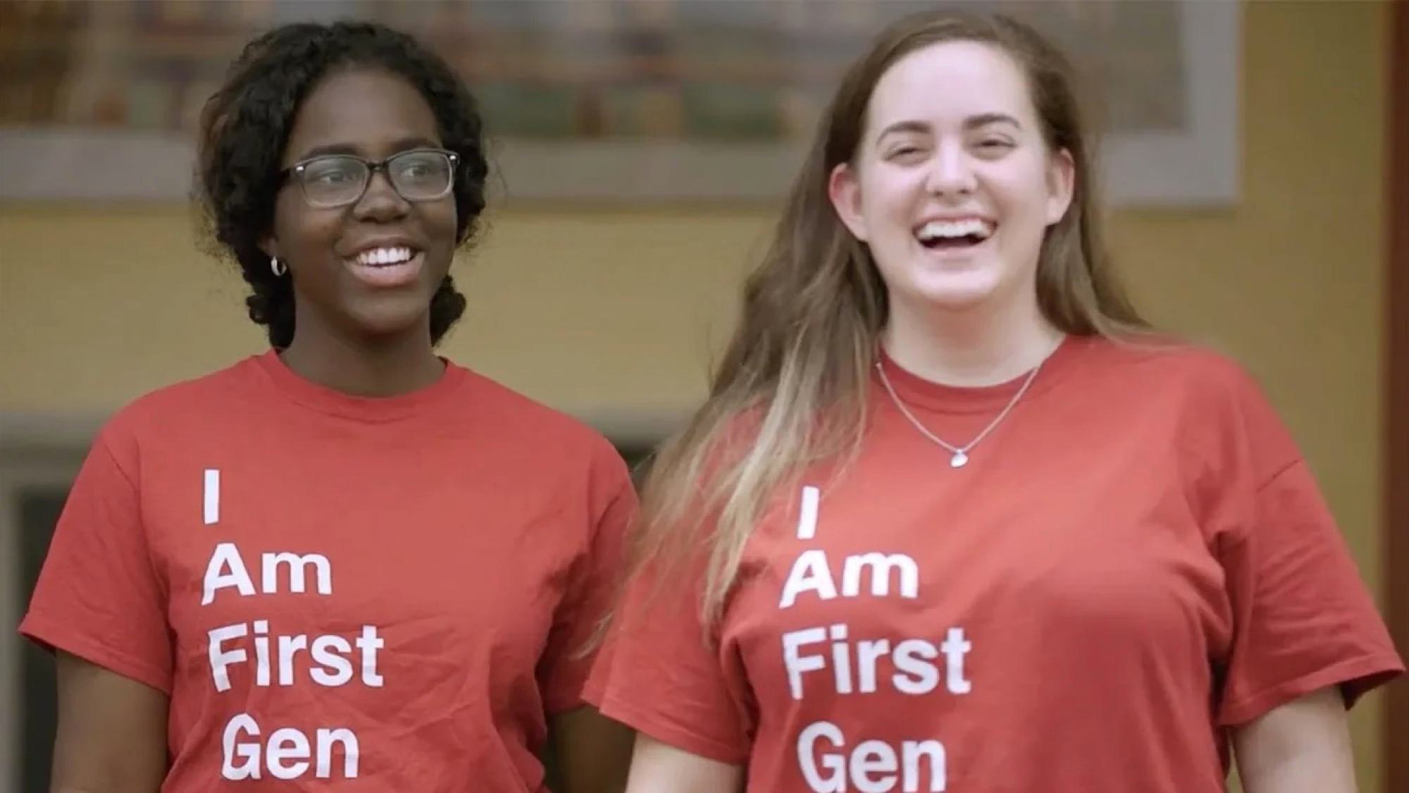 Two students smiling, wearing red "I am first gen" t-shirts