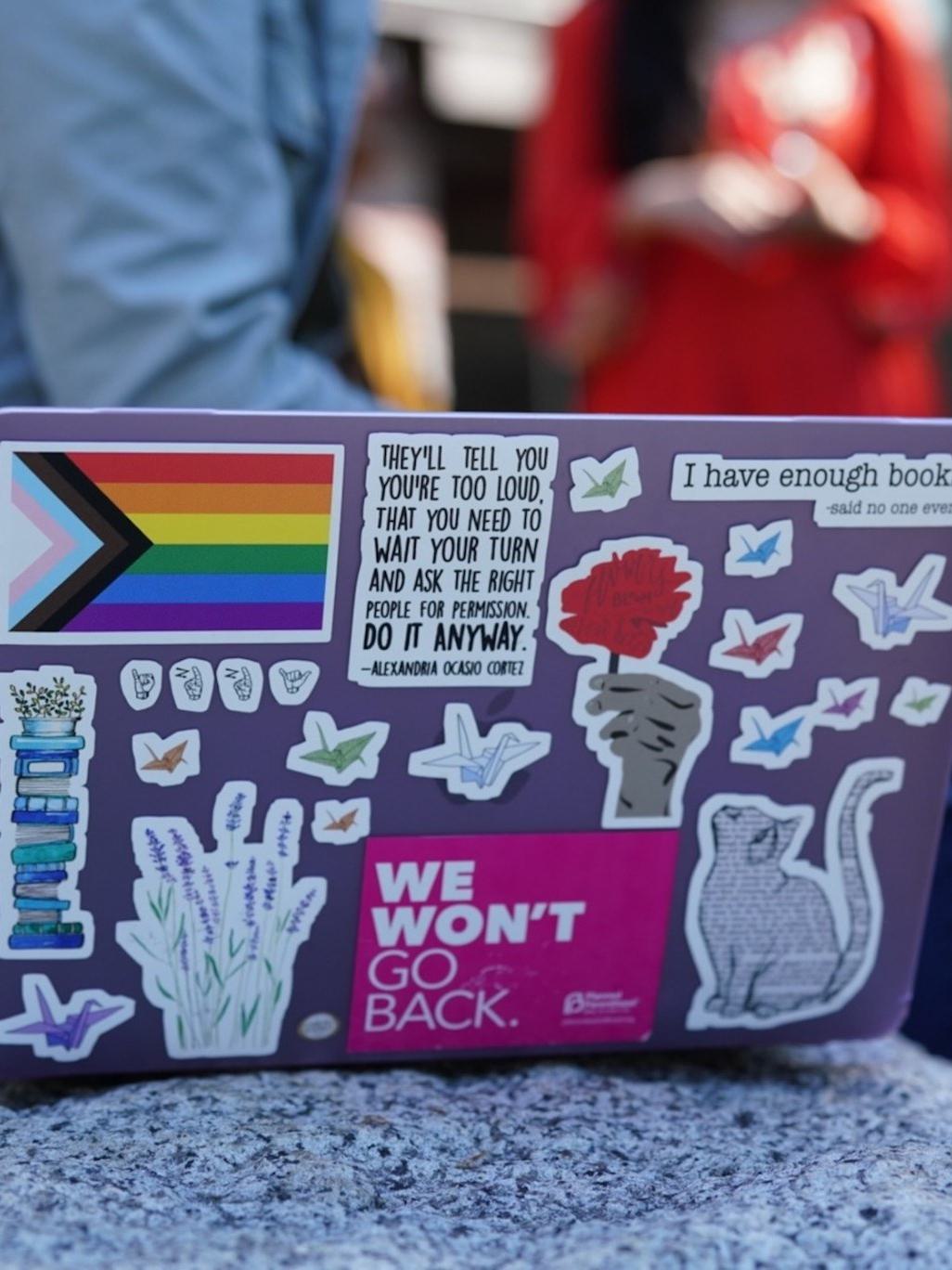 Laptop covered in stickers.