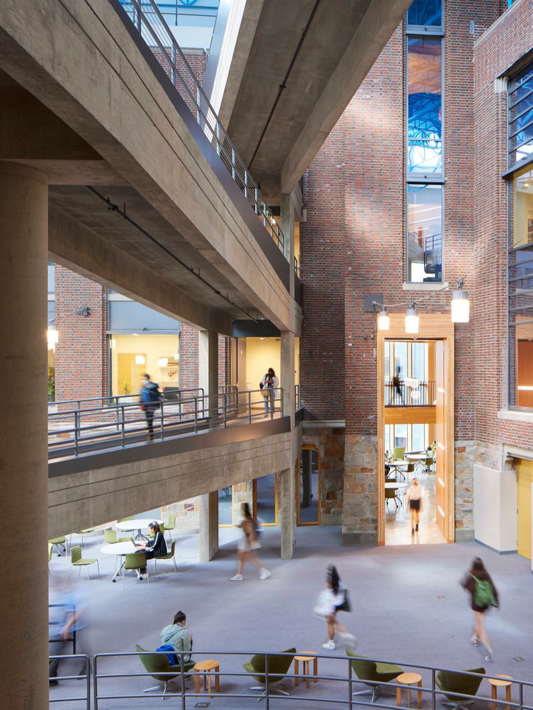 Blurred motion as students walk through multiple levels of the Science Complex.