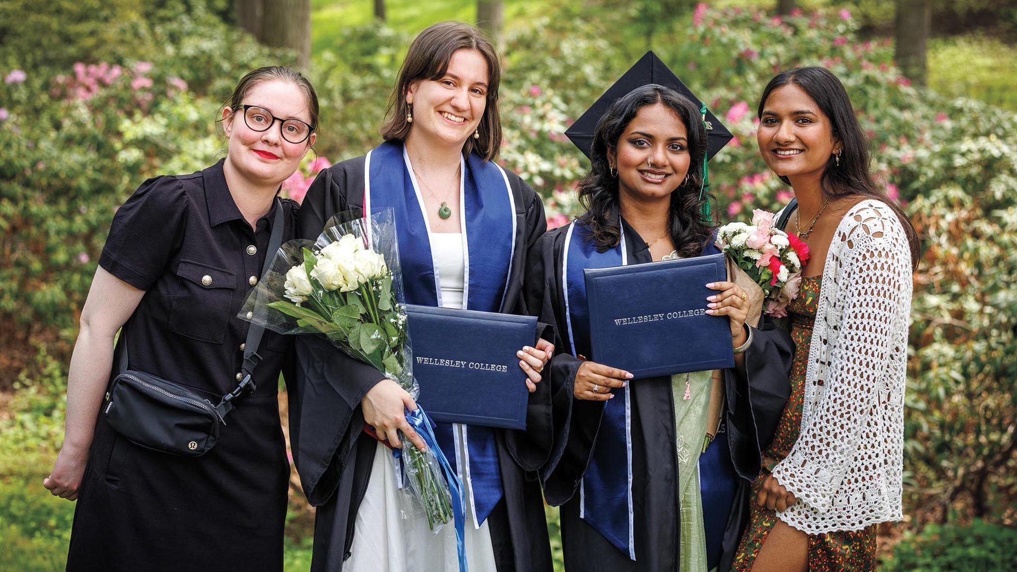 Photo of two students celebrating with loved ones after commencement