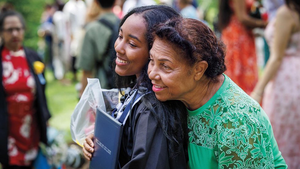 A student poses with a loved one for a photo after the ceremony