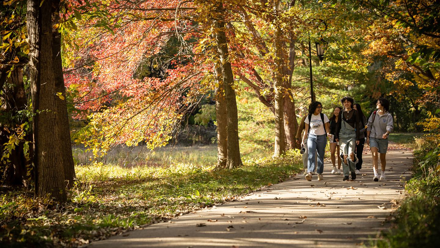 Students walking on a path by the Science Complex