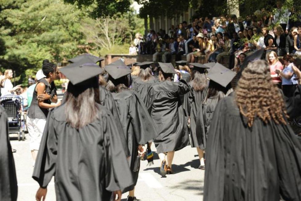 Students dressed in graduation gowns.