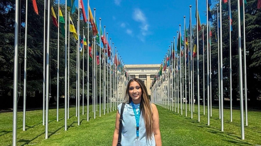 Student standing in front of the Palais des Nations in Geneva, Switzerland