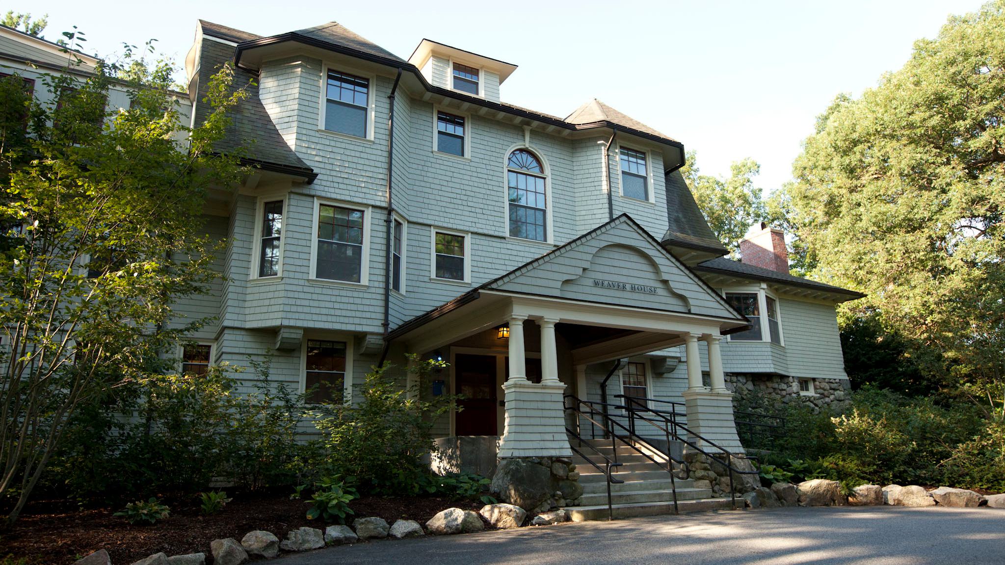 Image of Weaver House in the summer with green trees.