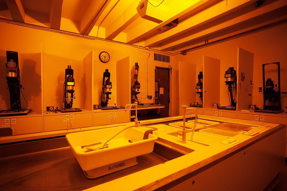 An empty dark room illuminated in orange light.