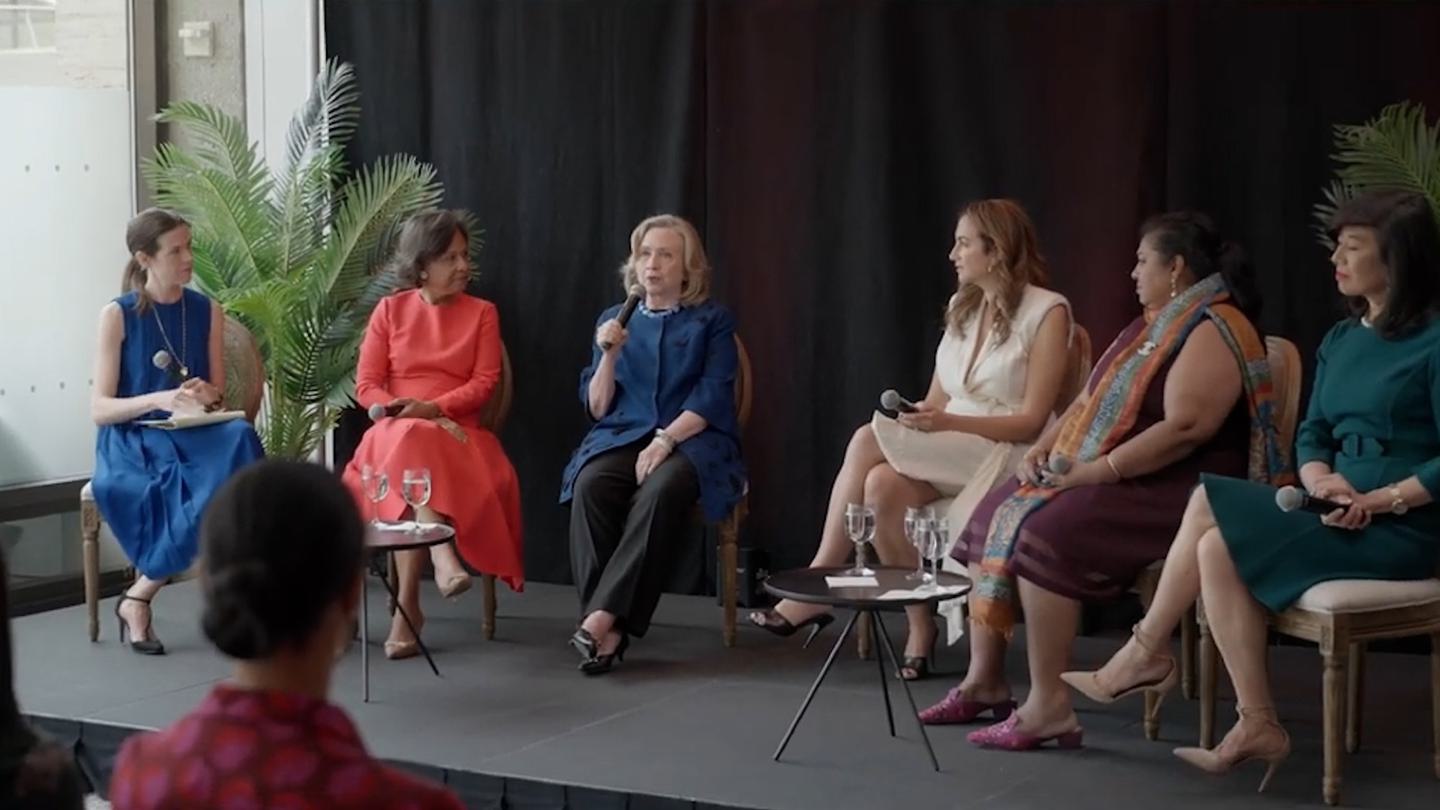 Six women, including Wellesley President Paula Johnson and Hillary Rodham Clinton ’69, converse on stage during a panel discussion.