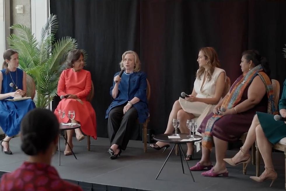 Six women, including Wellesley President Paula Johnson and Hillary Rodham Clinton ’69, converse on stage during a panel discussion.