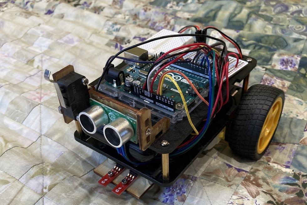 Student-made electric car with an Arduino Uno on it.
