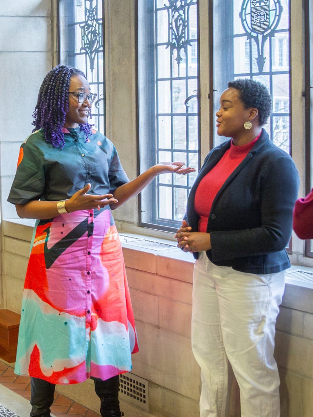 A student talks with a faculty member and a staff member.