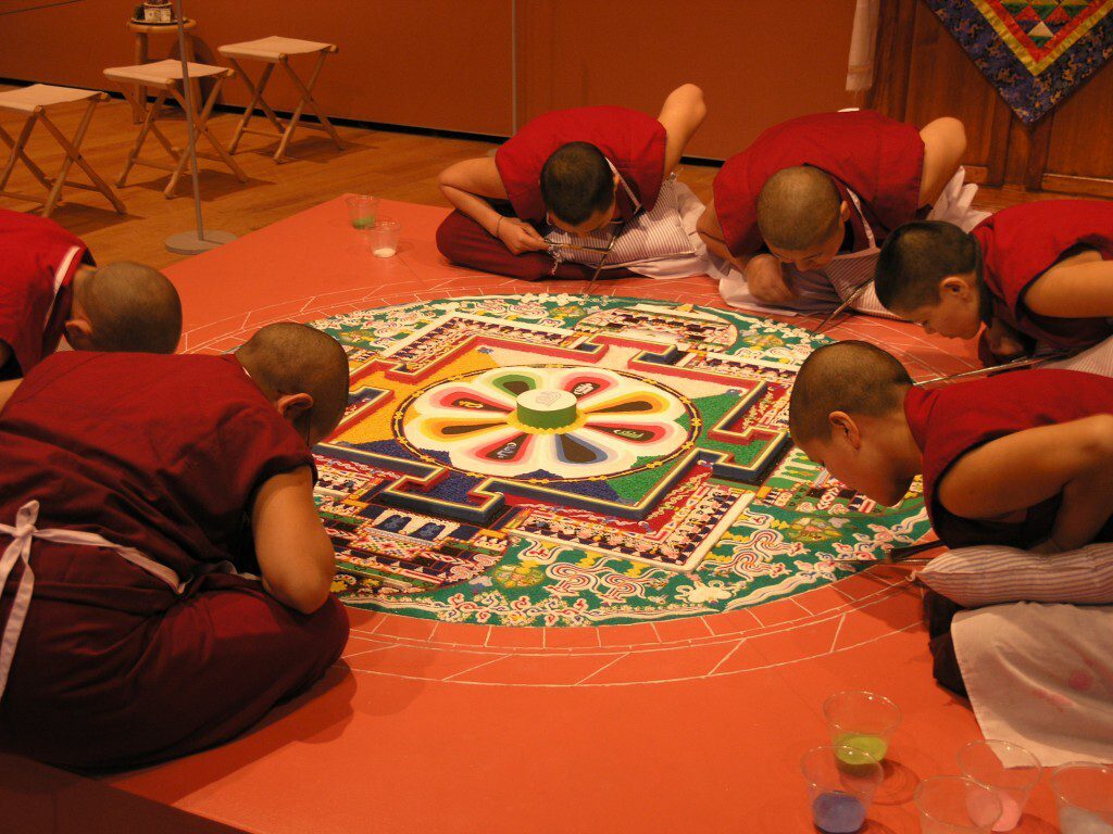 Sacred Sand Mandala Being Created by Tibetan Buddhist Nuns Sitting in Circle