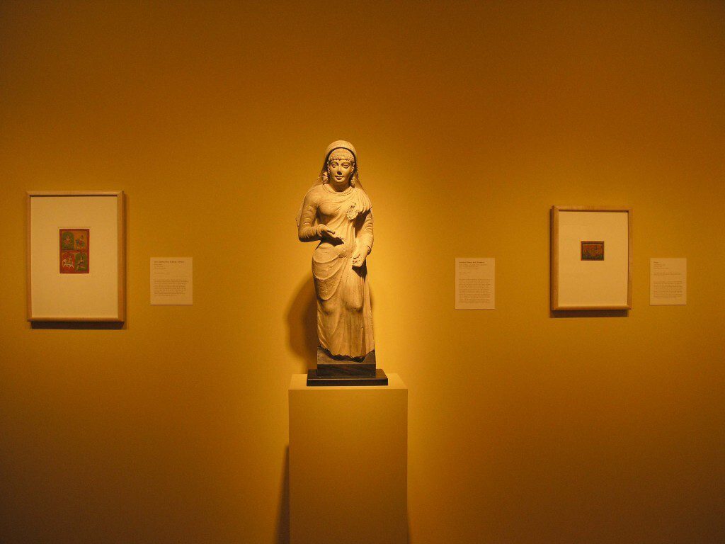 Statue on a pedestal featured in a museum
