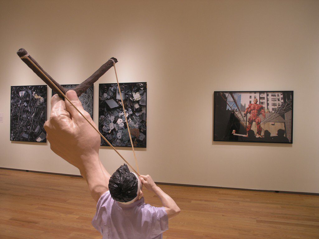 Composed photograph featuring a person taking aim with a slingshot
