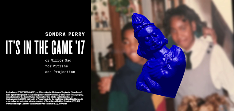 A portion of a blue figure hovers over a photograph of two people in the background