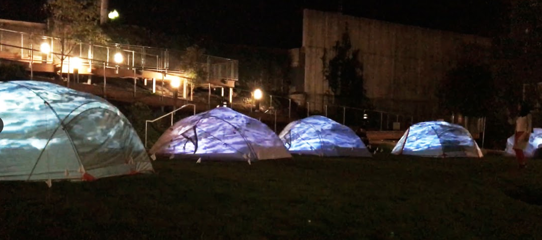 outdoor video installation, consisting of 5 temporary shelters housing individual video projections