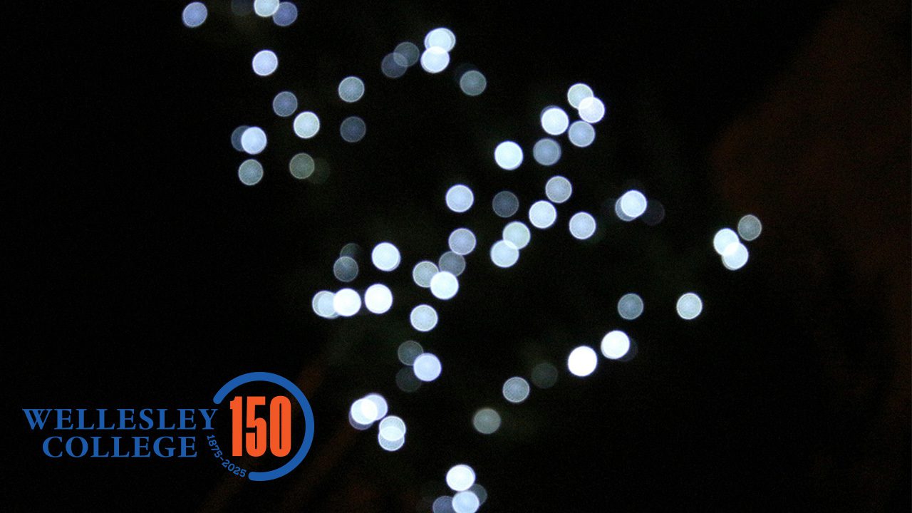 Blurred, circular lights against a dark background with 150th anniversary logo