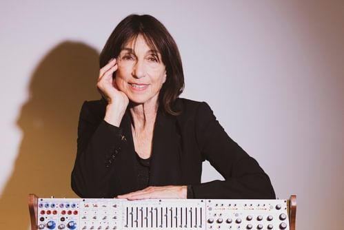 Suzanne Ciani with her arm resting on her synthesizer