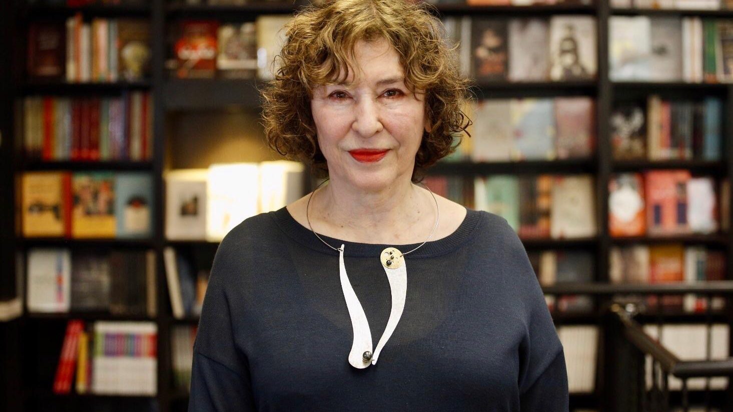 Azar Nafisi in front of bookshelf