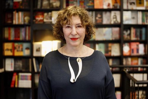 Azar Nafisi in front of bookshelf