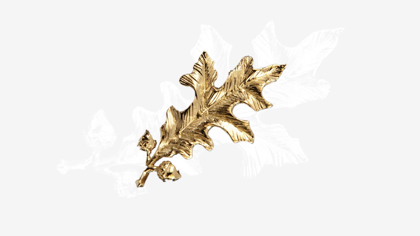 a gold-tone oak leaf and acorn motif