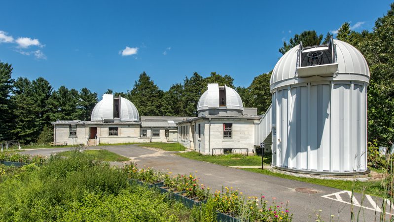 Whitin Observatory beneath a clear blue sky.