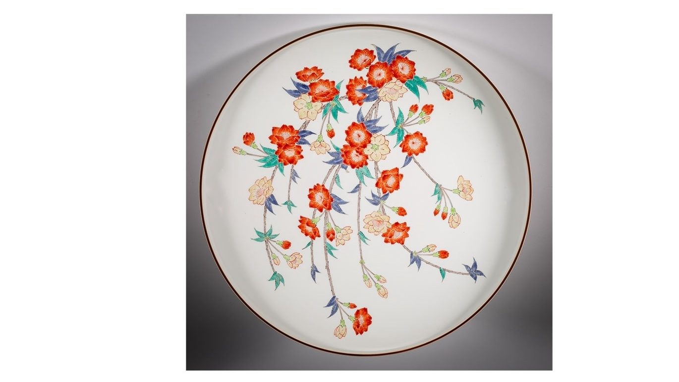 White porcelain plate painted with colored enamels in a weeping cherry blossom design