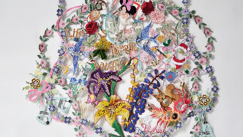 Object consisting of colorful, artfully arranged scraps of embroidery and needlework
