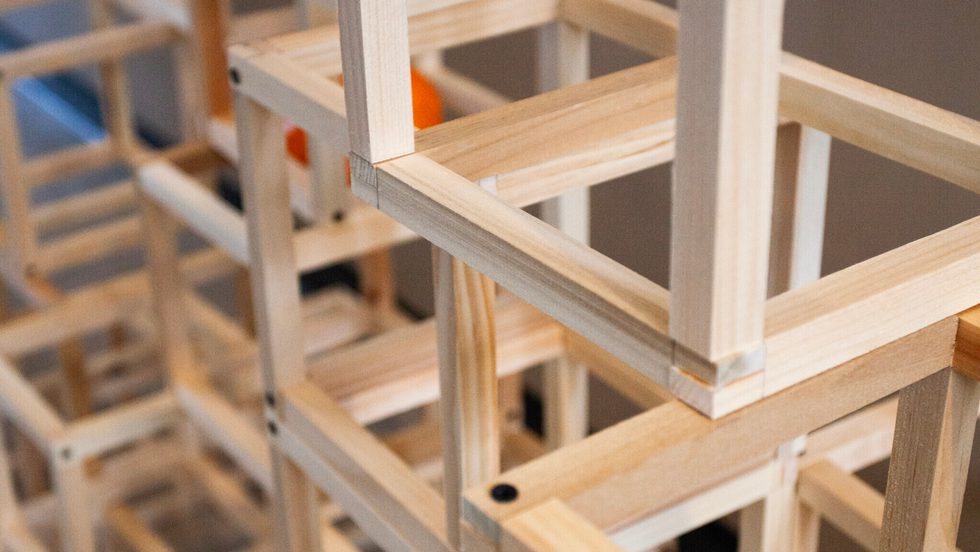 close up on complex structure made of many open wood cubes